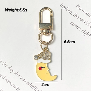 Cute gold alloy star moon rainbow keychain with Christmas hat and white rhinestones