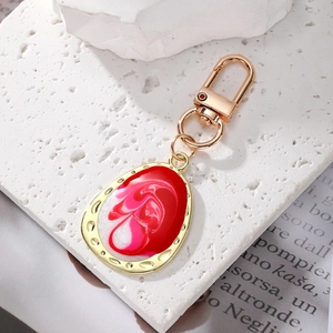 Bohemian geometric marble teardrop keychain with golden alloy finish and red enamel detail