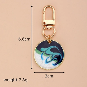 Detailed size view of bohemian round enamel keychain with blue texture and gold lobster clasp