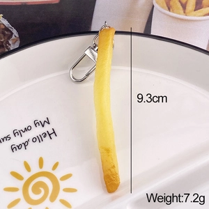 Realistic French fries keychain detail showing 9.3cm length and 7.2g weight on a plate