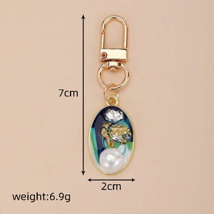 Detailed view of enamel key ring with pearls and zircon, measuring 7cm in height
