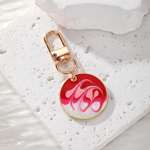 Detail of bohemian round keychain with colorful marble pattern and gold lobster clasp