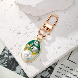 Vintage green enamel keychain with large white pearl and crystals on gold plating