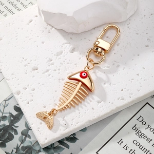 Golden fish bone keychain with evil eye detail and alloy spring clasp accessory