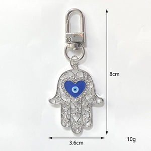 Detail of Hamsa hand keychain with blue heart evil eye and crystal inlays 8cm height