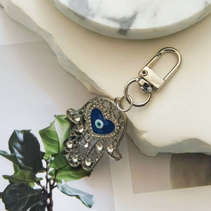 Vintage silver Hamsa hand keychain with blue heart evil eye and sparkling rhinestones