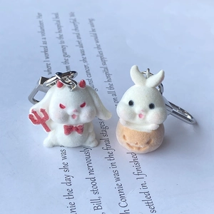 Cute flocked rabbit keychains featuring devil and pumpkin Halloween styles with silver hooks