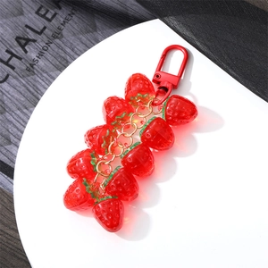 Detailed macro view of translucent red strawberry beads with a red matte metal hook
