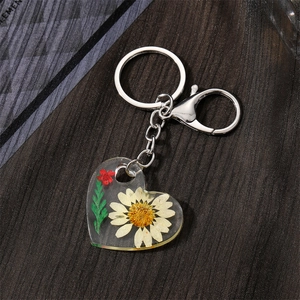 Handmade clear resin heart keychain with real dried daisy and silver lobster clasp
