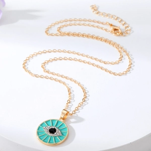 Golden Evil Eye heart pendant necklace with turquoise enamel and sparkling white crystals