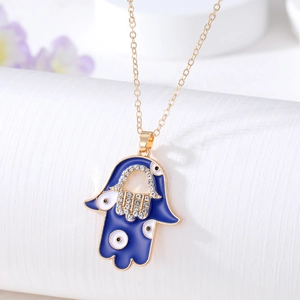 Detail of Hamsa Hand pendant with blue enamel, sparkling rhinestones and evil eye charms