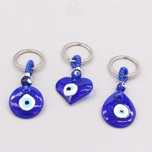 Detailed set of round, heart, and teardrop evil eye glass charms on silver keychains