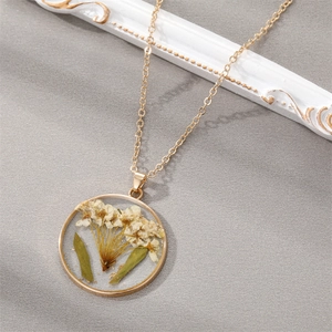 Detail of a vintage resin pendant necklace with real dried baby's breath flowers