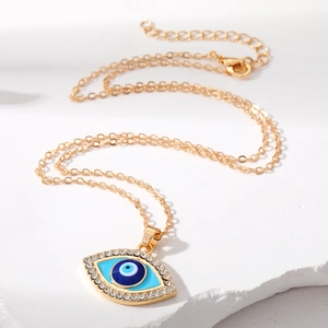 Vintage gold evil eye pendant necklace with blue center and sparkling zircon stones