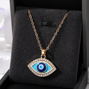 Vintage evil eye pendant necklace with blue crystals in a black jewelry box