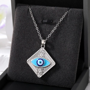 Detailed macro view of an evil eye diamond necklace displayed in a black jewelry box