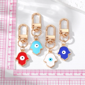 Set of four colorful Hamsa Hand and Evil Eye keychains with golden metal finish
