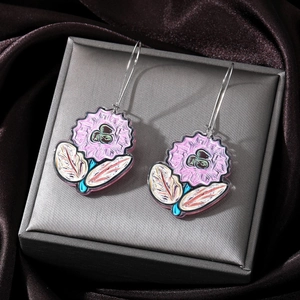 Detail view of pink acrylic flower earrings with green leaves on a jewelry box