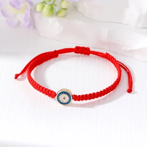 Handmade red braided Evil Eye bracelet with blue enamel charm and adjustable gold closure