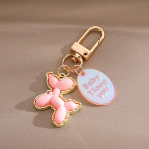 Pink resin balloon dog keychain with golden edge and Baby I Love You engraved tag