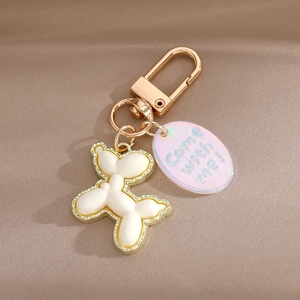 White resin balloon dog keychain with golden alloy frame and Come with me tag