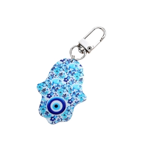 Bohemian Hamsa Hand keychain with blue evil eye charm and floral pattern on white background