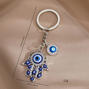 Detailed view of Hamsa Evil Eye keychain with blue eye charms and silver metal finish
