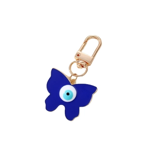 Porte-clés papillon bleu foncé avec breloque œil porte-bonheur et fermoir doré