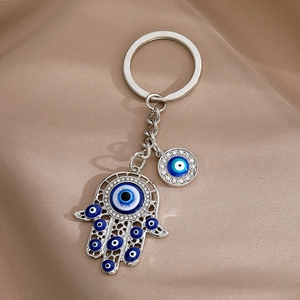 Hamsa Hand and Blue Evil Eye keychain in silver alloy with rhinestones and enamel detail