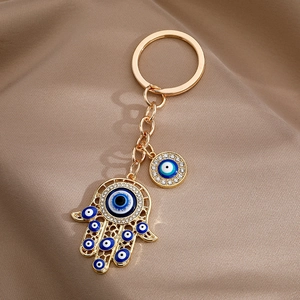 Hamsa Hand and Evil Eye gold keychain with crystal rhinestones on silk fabric