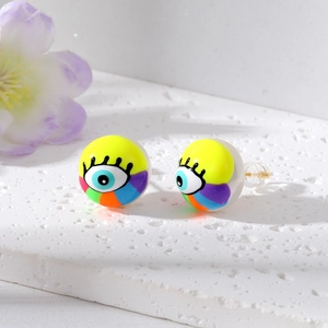 Close-up of pearl studs with colorful evil eye graffiti and long eyelashes design