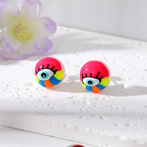 Detailed close-up of colorful evil eye stud earrings with vibrant pink resin and striped accents