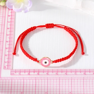 Red braided rope bracelet with pink Evil Eye charm and adjustable pull string closure