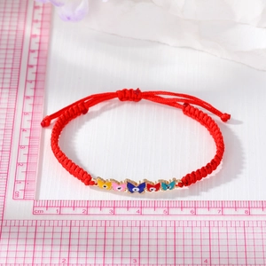 Red braided cord bracelet with five colorful enamel butterfly evil eye charms