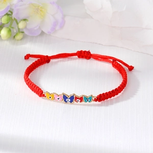 Detail of red braided bracelet with colorful butterfly evil eye charms and sliding knot