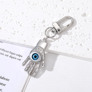 Detailed macro view of the silver Hamsa hand keychain with a blue evil eye and lobster clasp