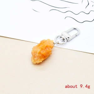Macro shot of a realistic resin fried chicken nugget keychain with silver metal lobster clasp