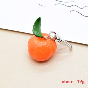 Detail of realistic orange keychain resin fruit charm with silver metal carabiner, 19g