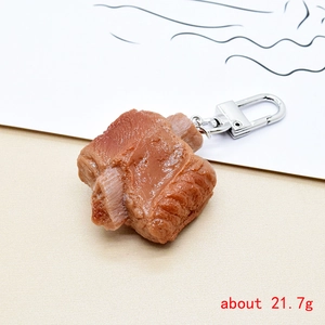 Detailed side view of a realistic resin braised pork rib keychain with glossy sauce texture