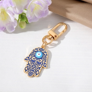 Vintage gold alloy Hamsa Hand keychain with blue evil eye and floral enamel patterns