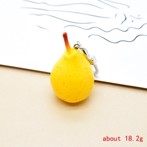 Detailed view of creative resin pear keychain with silver ring and realistic texture
