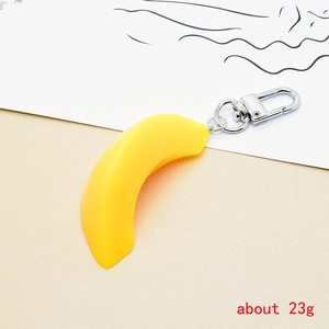 Detailed close-up of a realistic banana shaped keychain with a silver lobster clasp