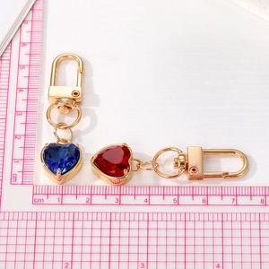 Minimalist heart-shaped crystal keychains in deep blue and red with gold-plated lobster clasps
