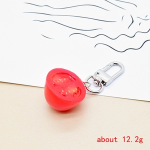 Detailed macro view of realistic 12.2g cherry tomato keychain with silver metal clasp