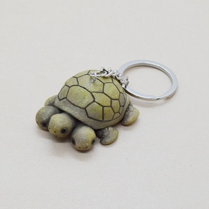 Unique three-headed turtle keychain made of resin with creative green turtle shell design