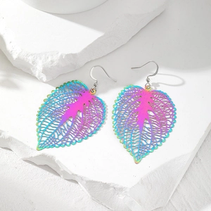 Rainbow gradient leaf hollow earrings in minimalist design on stone background