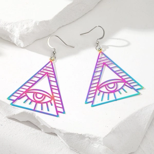 Macro detail of rainbow iridescent tree of life earrings on white textured stone