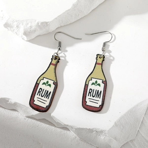 Macro detail of wood rum bottle earrings on a stone texture background