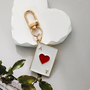 Ace of Hearts poker card keychain in white and gold enamel with a metal D-ring clip