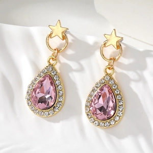 Elegant gold drop earrings with pink crystals and star studs in a luxury aesthetic